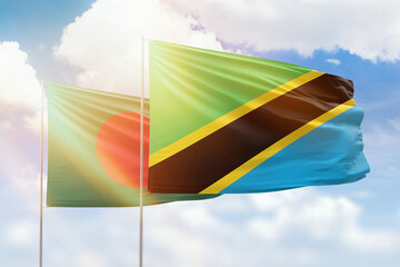 Sunny blue sky and flags of tanzania and bangladesh