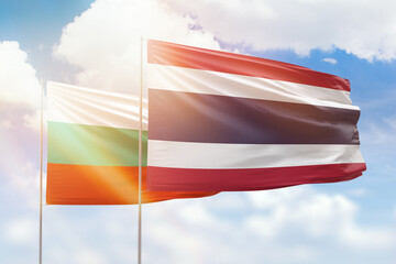 Sunny blue sky and flags of thailand and bulgaria