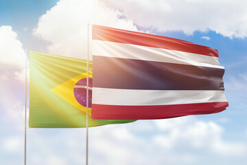 Sunny blue sky and flags of thailand and brazil