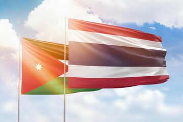 Sunny blue sky and flags of thailand and jordan