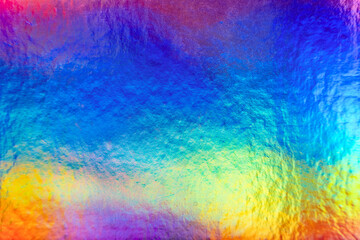 Rainbow colorful metallic holographic iridescent foil background texture