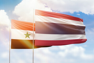 Sunny blue sky and flags of thailand and syria