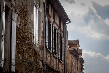 Fototapeta na wymiar Facade of old houses, medieval buildings, in a typical french medieval village and city, bergerac, in France, in Dordogne and Perigord, with a typical of the Southwestern French architecture...