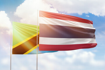Sunny blue sky and flags of thailand and tanzania