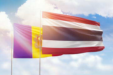 Sunny blue sky and flags of thailand and andorra