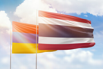 Sunny blue sky and flags of thailand and armenia