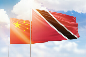 Sunny blue sky and flags of trinidad and tobago and china
