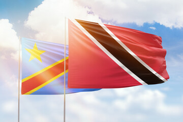 Sunny blue sky and flags of trinidad and tobago and dr congo