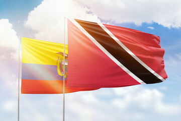 Sunny blue sky and flags of trinidad and tobago and ecuador
