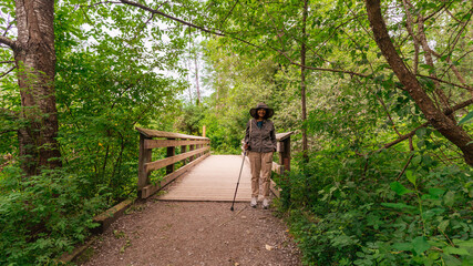 Fototapeta premium Senior enjoying a Spring walk on the Port Moody, BC, section of the Great Trail.