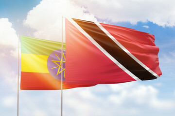 Sunny blue sky and flags of trinidad and tobago and ethiopia