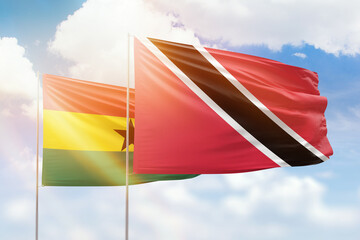 Sunny blue sky and flags of trinidad and tobago and ghana