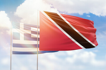 Sunny blue sky and flags of trinidad and tobago and greece
