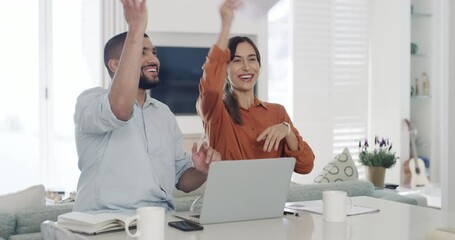 Excited happy family couple sitting on sofa and throwing up papers or documents while paying bills online on a laptop at home. Husband and wife celebrating approved mortgage loan - Powered by Adobe