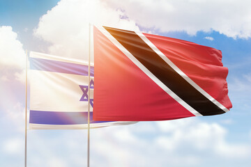 Sunny blue sky and flags of trinidad and tobago and israel