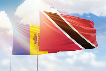 Sunny blue sky and flags of trinidad and tobago and moldova