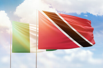 Sunny blue sky and flags of trinidad and tobago and nigeria