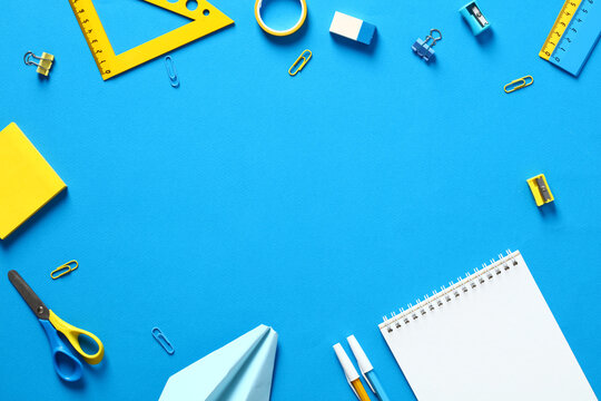 Back to school concept. Flat lay school supplies and stationery on blue background. View from above.