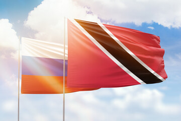 Sunny blue sky and flags of trinidad and tobago and russia