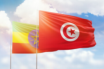 Sunny blue sky and flags of tunisia and ethiopia