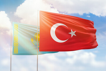 Sunny blue sky and flags of turkey and kazakhstan