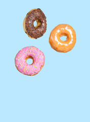 Fototapeta na wymiar Three Donuts on blue background.