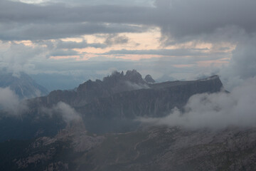 Fototapeta na wymiar Mountain landscape in dense clouds. The Cinque Torri seen from above of South side, Dolomites.
