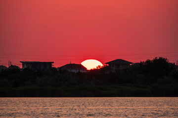 Fototapeta na wymiar The sun goes down over a lake