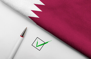 Pencil, Flag of Qatar and check mark on paper sheet 