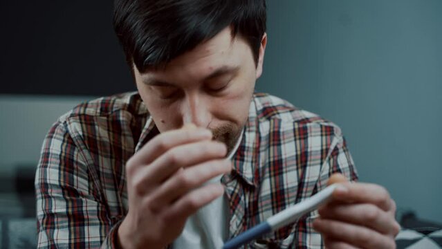 I am far to young to be father. Guy looks at result of pregnancy test and is very upset. I am not gonna be daddy anymore. Male frustrated with pregnancy test at home. Thinking of having an abortion