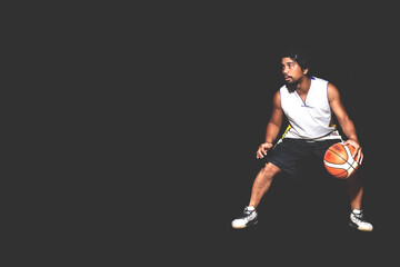 Plakat Gesture of Asian basketball player dribbling on black background. Basketball concept in Asia
