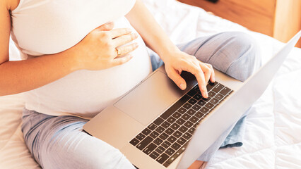 Pregnancy app laptop. Mobile pregnancy online maternity notebook application. Pregnant mother using digital computer. Concept of pregnancy, maternity, expectation for baby birth.