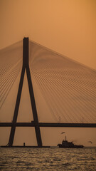 sunset near mumbai worli bandra sea link bridge and small boat in ocean