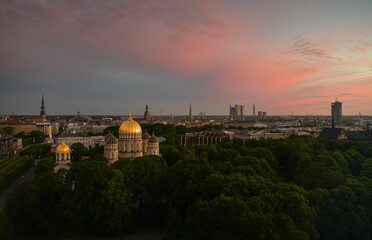 Fototapeta na wymiar Beautiful summer sunset over the central district of Riga, with view to Freedom Monument, Old town and Cathedral. Landmarks of Latvia.