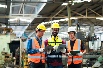 Professional Mechanical Engineer team Working on tablet computer at Metal lathe industrial manufacturing factory. Engineer Operating lathe Machinery. Product quality Inspection