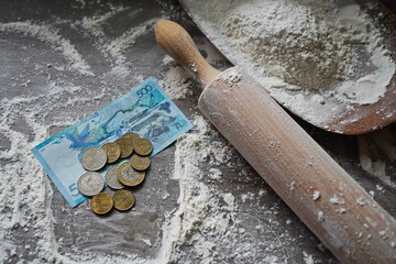 Kazakhstani tenge is lying on the table with scattered flour.