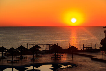 Fototapeta na wymiar Luxury swimming pool with sea view at sunrise. Concept of rest, relaxation, holidays, resort
