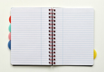 Open notebook with white lined pages, isolated on white background