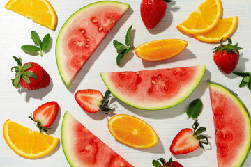 Fresh and juicy fruits on white wooden background