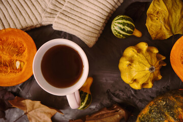 Cup hot tea on the gray table with pumpkin, leaves, spices on the background. Autumn concept. Top view. High quality footage