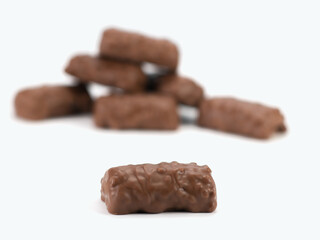 Crispy bits of chocolate bars. Chocolate bars with peanuts and caramel. Selective focus. Close up view.