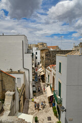 A narrow street among the old houses in the historic center of Otranto, a town in Puglia in Italy.