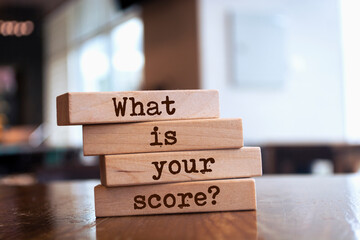 Wooden blocks with words 'What is your score?'.