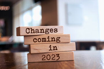 Wooden blocks with words 'Changes coming in 2023'. - obrazy, fototapety, plakaty