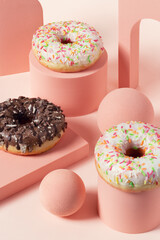 Sweet donuts on pink cubes on a pink background. Cake doughnut prepared for a Shrove Tuesday or for Mardi gras