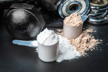 Scoop of protein powder and dumbbell background,Sports supplement,Fitness or healthy lifestyle...