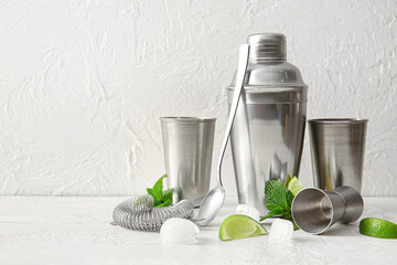 Set of cocktail utensils and ingredients on light table