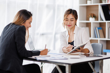 Cropped shot of Asian Business woman diverse coworkers working together in the boardroom, brainstorming, discussing, and analyzing business report strategy collaboration.