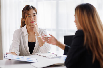 Cropped shot of Asian Business woman diverse coworkers working together in the boardroom, brainstorming, discussing, and analyzing business report strategy collaboration.