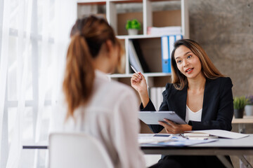 Cropped shot of Asian Business woman diverse coworkers working together in the boardroom, brainstorming, discussing, and analyzing business report strategy collaboration.